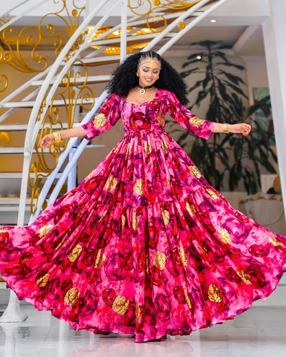 Woman in a vibrant pink and gold chiffion posing in an elegant interior setting.