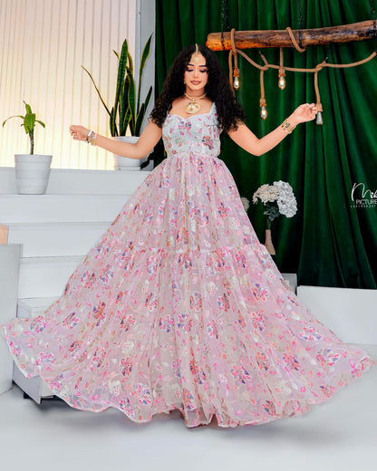 Woman in a floral Habesha Kemis posing in a decorated room with plants and decor.