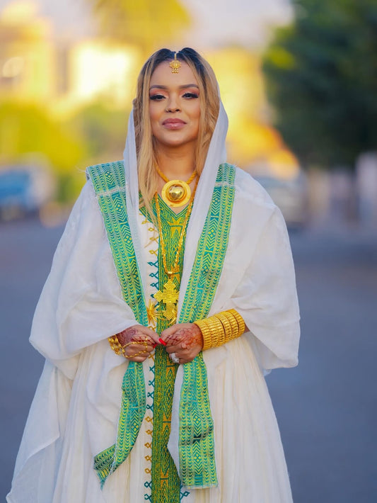 Woman in traditional Habesha Libs with a blurred background
