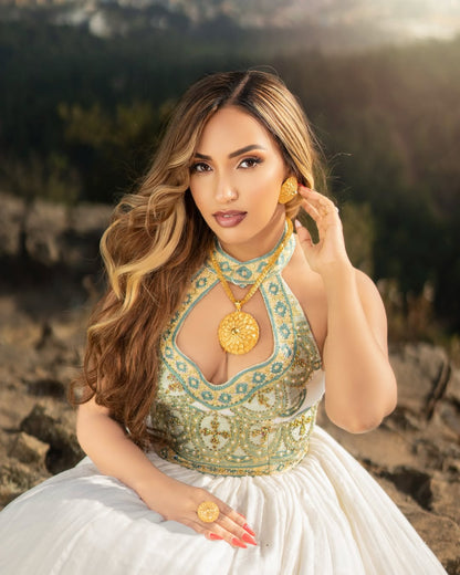 Woman in a scenic outdoor setting wearing Green Ethiopian dress.