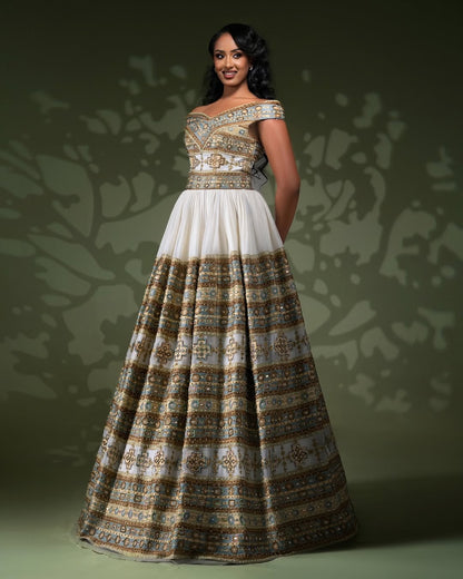 Woman wearing a patterned wide ethiopian habesha tibeb against a dark background