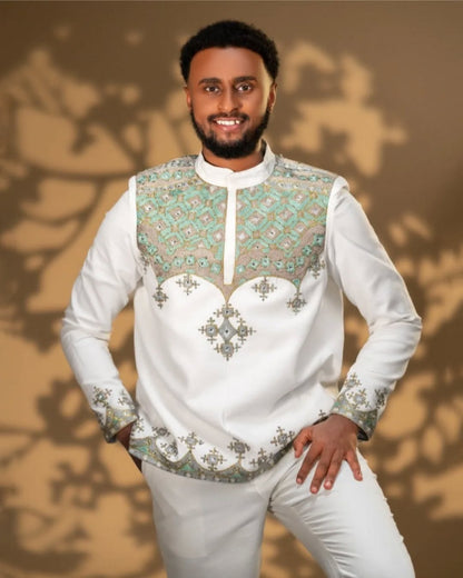 Man wearing a Men’s Traditional Shirt embroidered shirt with green patterns against a brown background